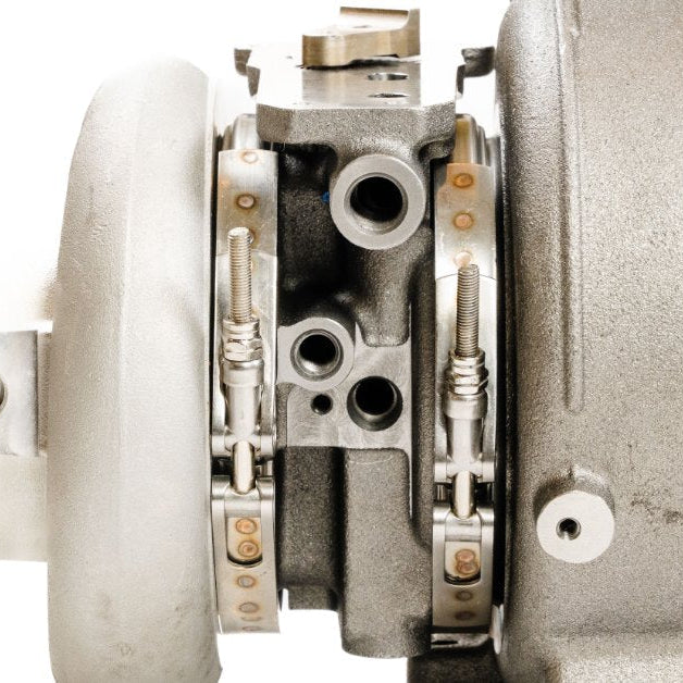 Side view of a diesel turbocharger, showing the compressor and turbine housings with the center cartridge assembly.