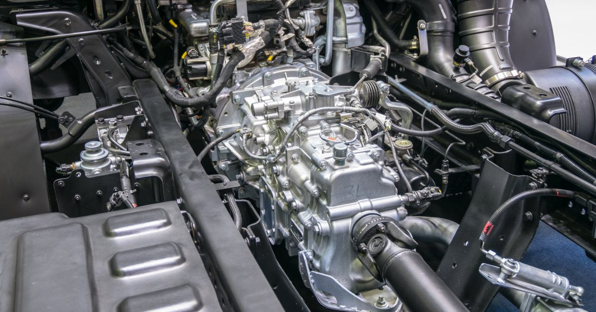 A diesel truck engine bay showing the turbocharger, intake piping, and engine components.