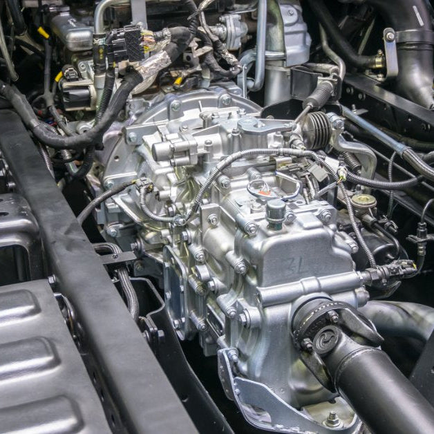 A diesel truck engine bay showing the turbocharger, intake piping, and engine components.