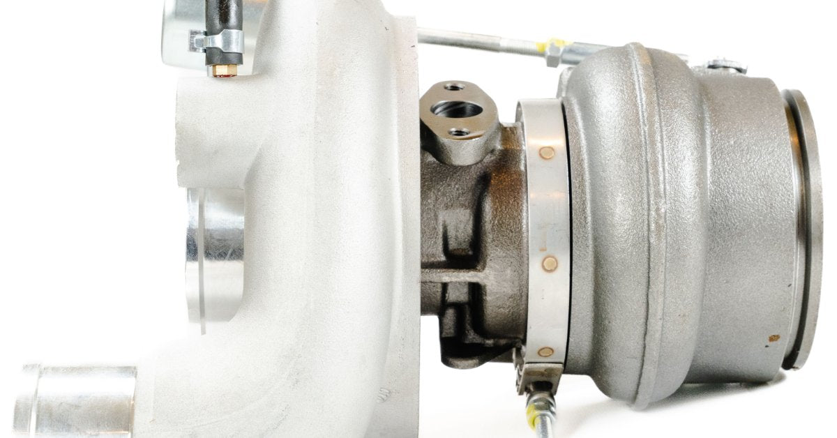 Side profile of a turbocharger assembly with compressor housing and actuator components visible.