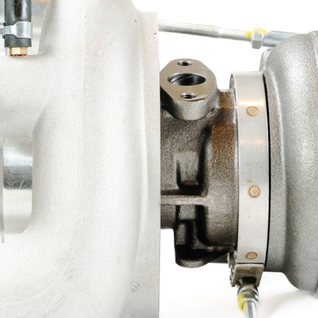 Side profile of a turbocharger assembly with compressor housing and actuator components visible.